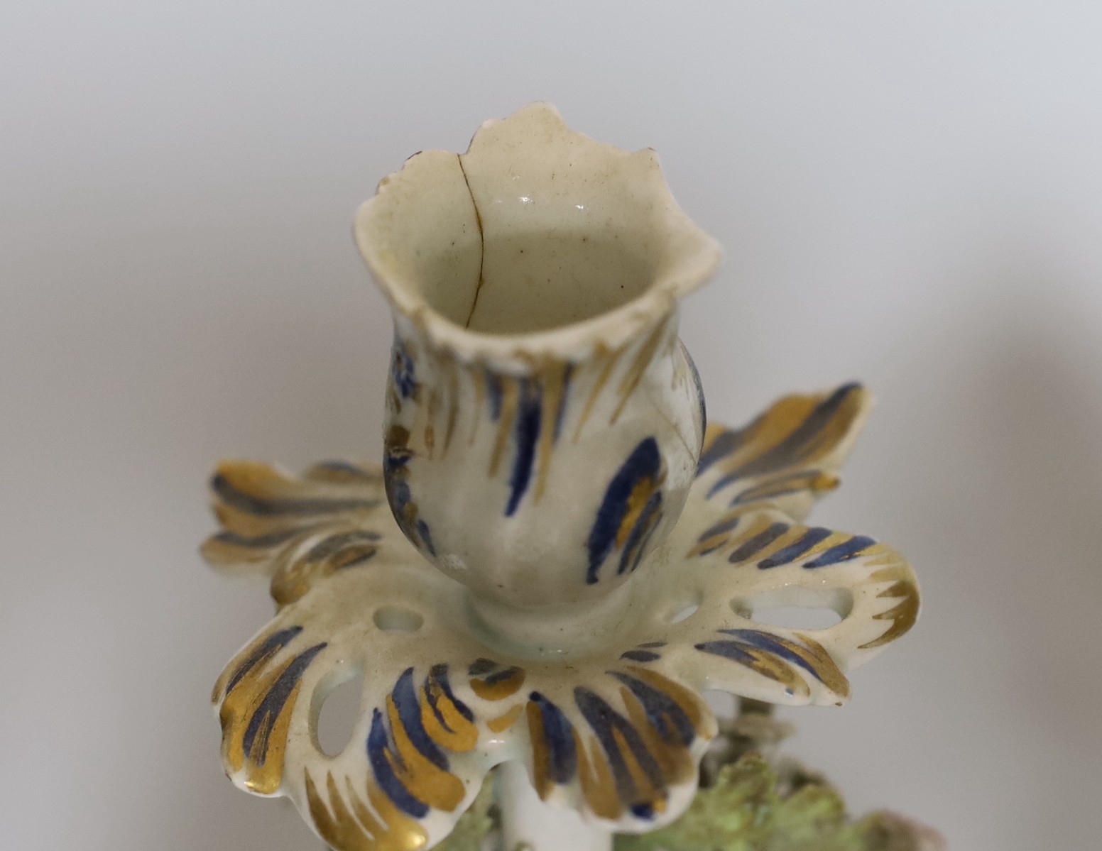 A pair of 18th century Bow putti figural candlesticks, 24cm